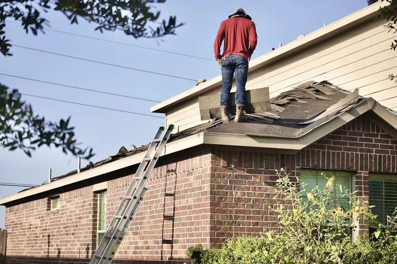 Professional roofer working on a residential roof in Catalina